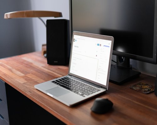A clean workspace surface featuring an organized desktop setup with a notebook