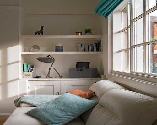 A bright apartment window allowing morning daylight to illuminate a tidy room setup