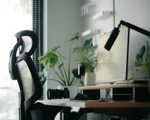A highly organized office chair and desk setup supporting good posture